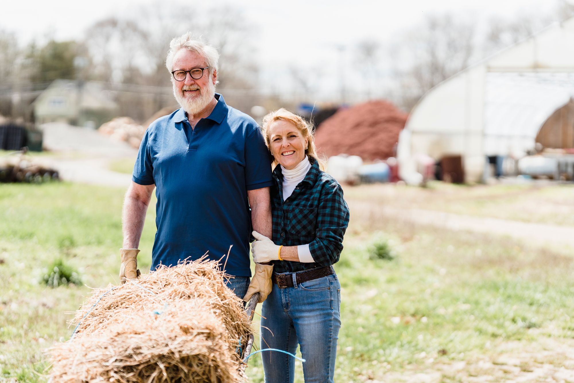 An older couple standing together on their farm